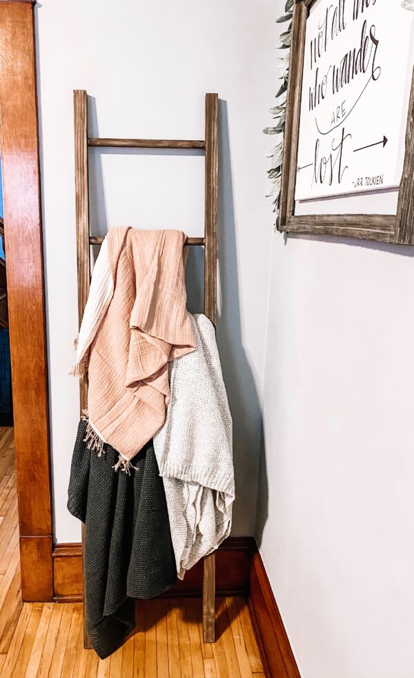 blanket ladder with blankets draped on it